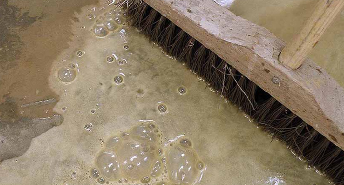 acid etch applied with broom on concrete floor