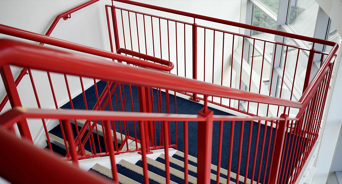 staircase with red-painted banisters